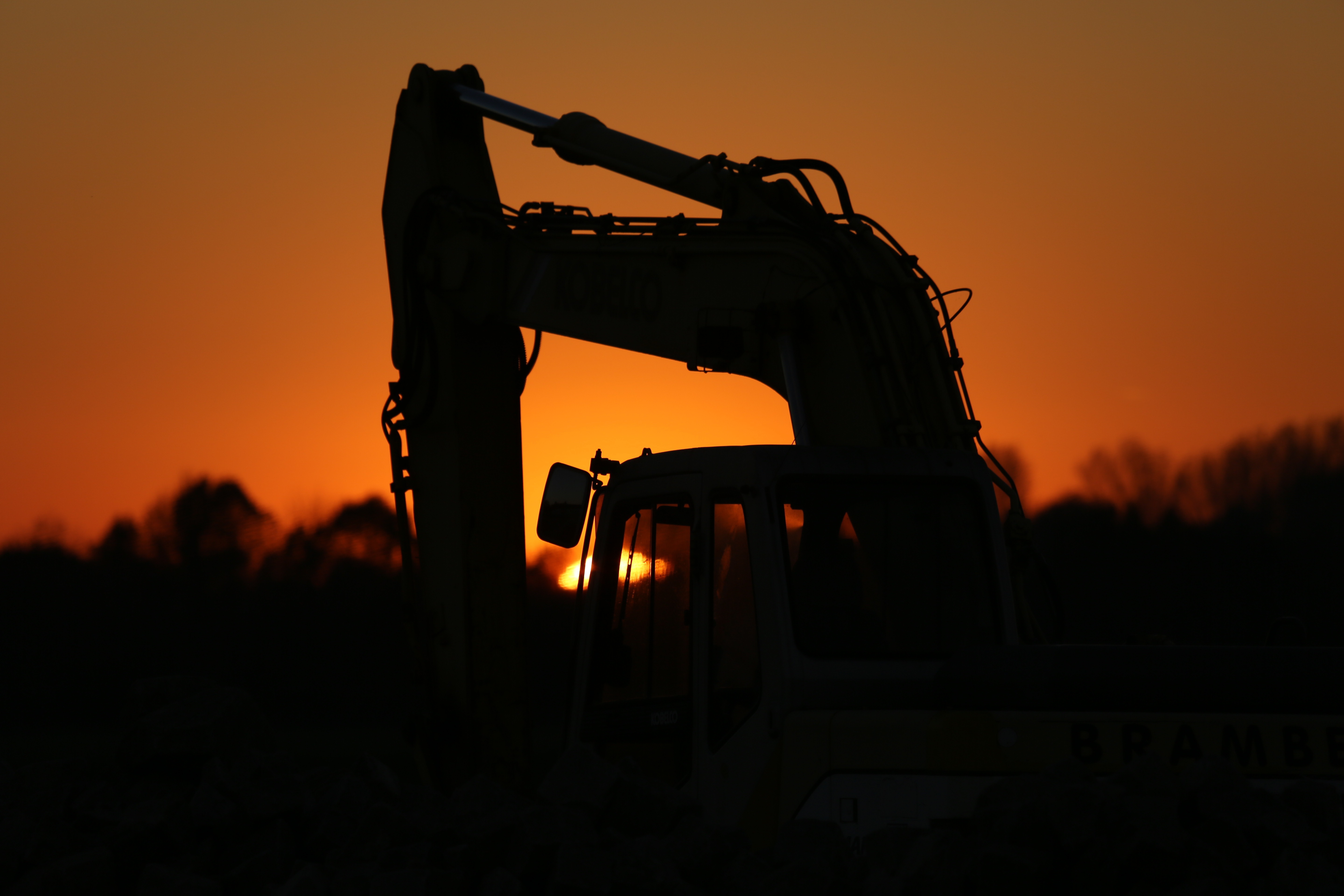 Heavy equipment silhouette at sunset